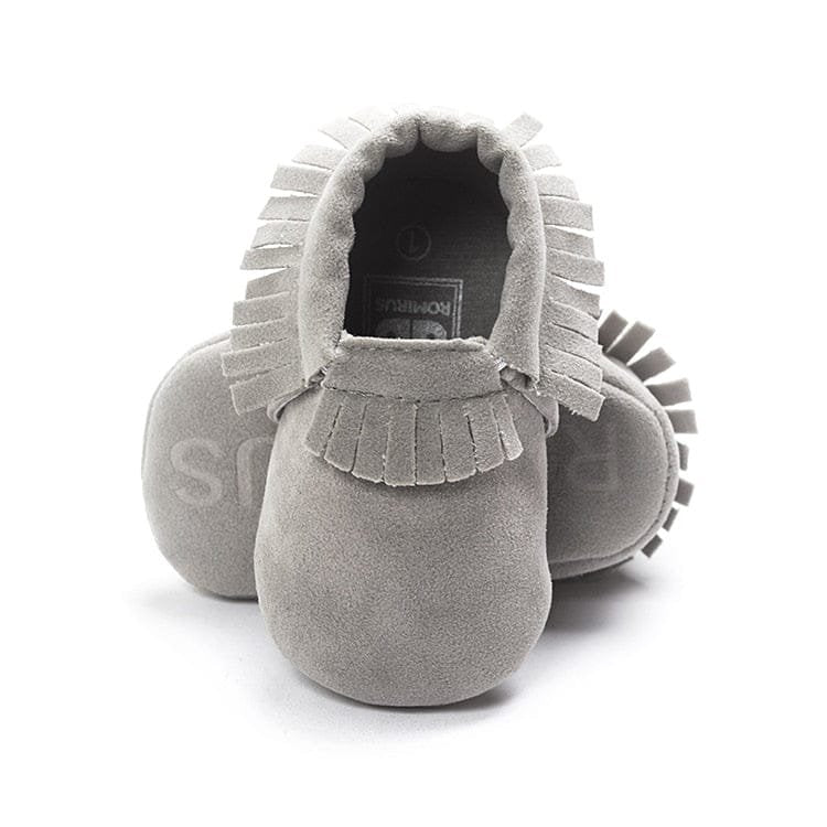 PU suede leather newborn baby moccasin shoes shown with gift packaging for newborn baby showers.