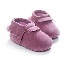 PU suede leather newborn baby moccasin shoes worn by a baby during everyday indoor play.
