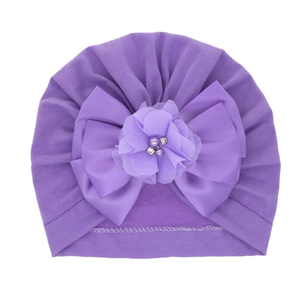 Purple floral bow baby turban in cotton for gentle head coverage during outings and special occasions.