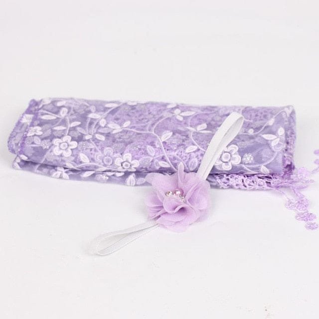 Purple floral newborn headband as a photography prop accessory for baby portraits and milestone photos.