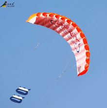 Colourful dual line parafoil kite in flight against a clear sky, easy to launch for beginner kite flyers.
