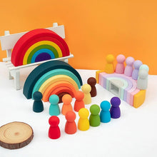 Silicone Baby Blocks rainbow arch set with peg figures for pretend play scenes and storytelling with toddlers.