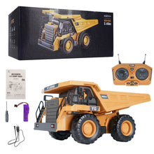 RC dumper truck boxed set with controller and battery for kids carting sand around their play area.