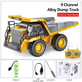 9 Channel Alloy Dump Truck with remote control, battery, charging cable, screwdriver, and manual.