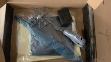 RC Flying Shark Balloon accessories and setup kit inside packaging for assembling the remote control flying toy.