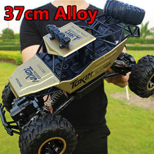 1:12 scale RC monster truck with 37cm alloy body compared to hand size for reference.