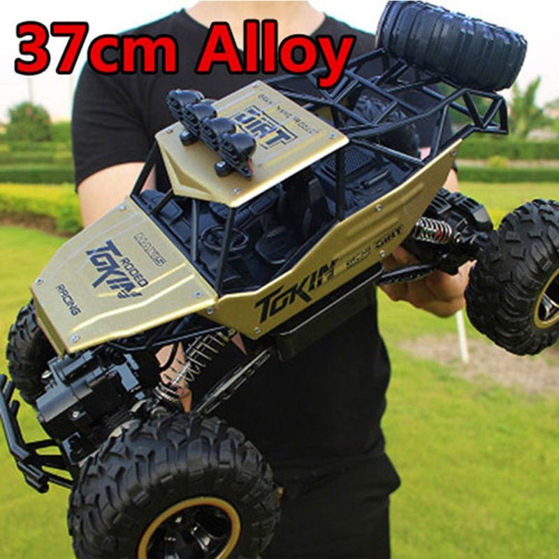 1:12 scale RC monster truck with 37cm alloy body compared to hand size for reference.