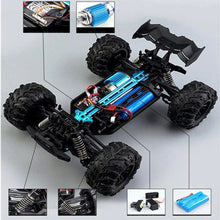 Chassis and drivetrain detail of the 4WD RC monster truck built to handle fast outdoor racing and jumps.