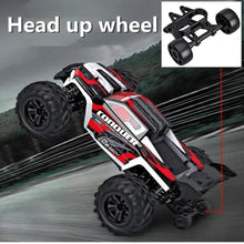 RC monster truck performing a head-up wheelie, a 4WD stunt toy for showing off tricks during outdoor play.