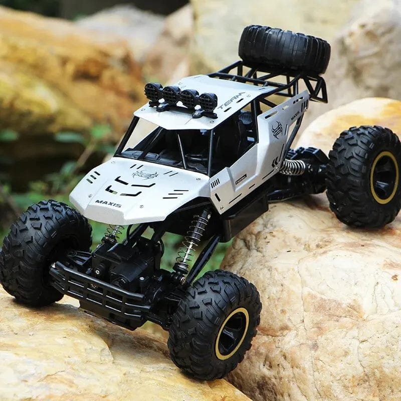 RC off-road truck climbing a rock obstacle, a 4WD buggy toy for outdoor exploring and terrain challenges.