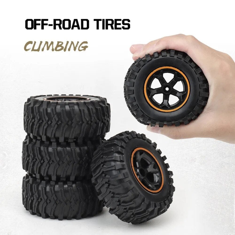 Off-road RC truck tyres with deep tread for grip on gravel, grass and dirt during outdoor racing.