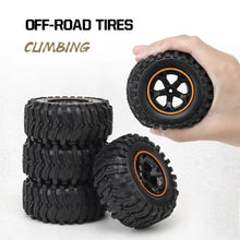 Off-road RC truck tyres with deep tread for grip on gravel, grass and dirt during outdoor racing.