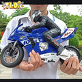 A Person holding a blue toy motorcycle 