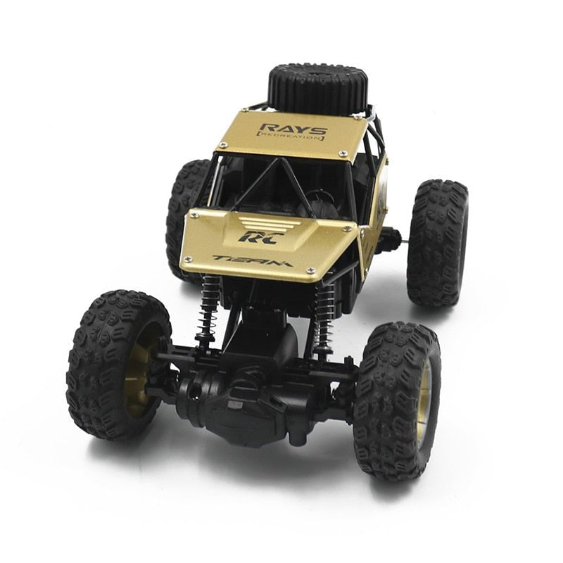 Black and gold RC truck chassis view showing the 4WD mechanics underneath.