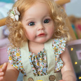 Baby doll with blonde hair and floral outfit in a blurred indoor setting