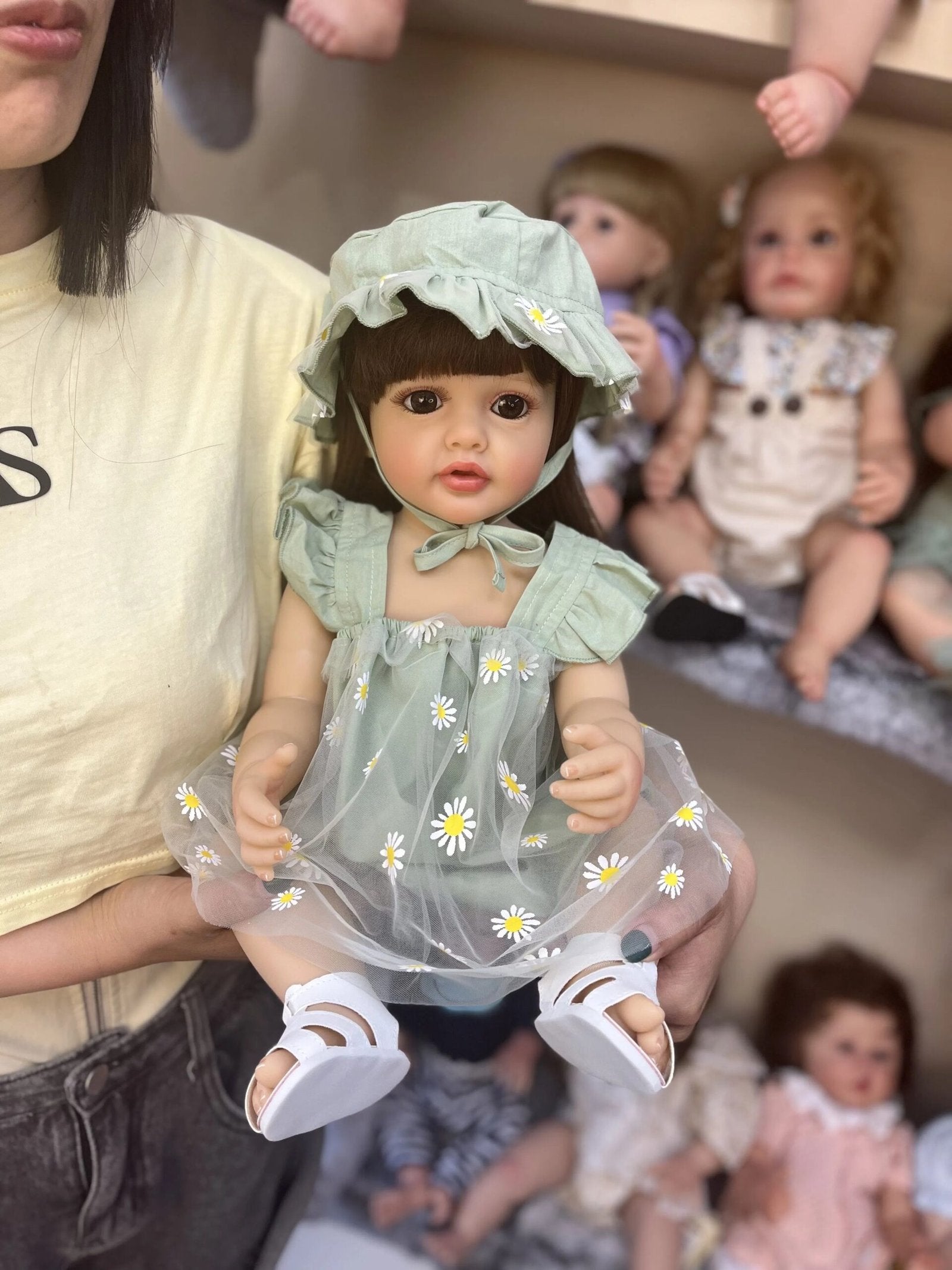 Realistic 55CM silicone Reborn Doll Princess Betty in a daisy print outfit, a handmade baby doll for holiday presents and nursery display.