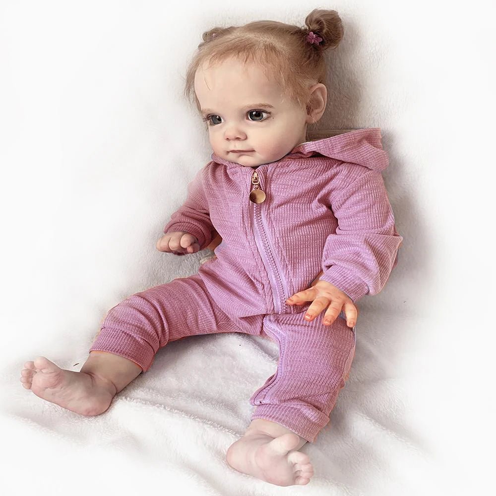 Realistic Maggi Reborn Doll 58cm with rooted hair in a purple and pink outfit for dress-up play and keepsake collecting.