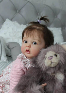 Realistic Reborn Baby Doll with 3D painted skin and silicone body holding a plush toy, ideal for nursery display and gifting.