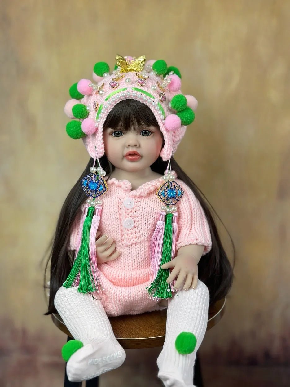 Realistic silicone Reborn Doll newborn girl in a traditional outfit and headpiece for collecting, display, and cultural gifting.