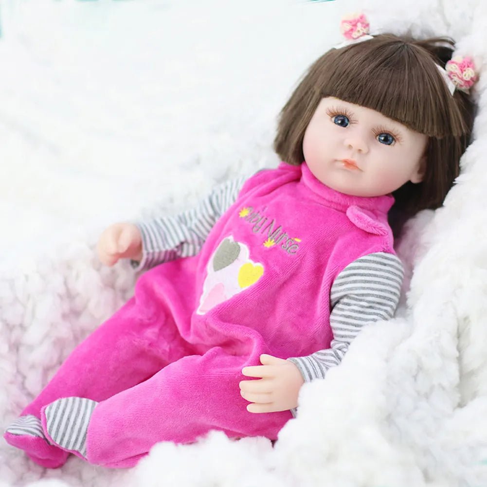 Doll wearing a pink outfit with a cartoon design on a white background