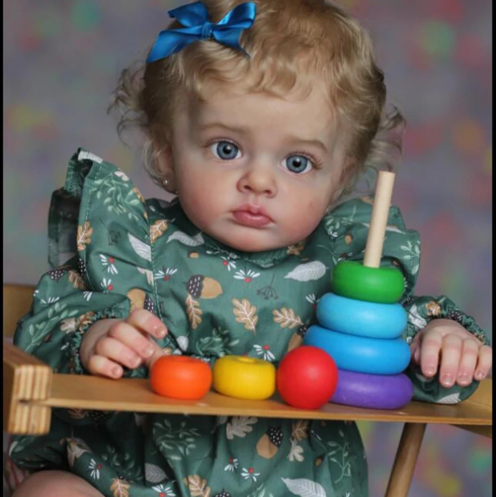 Realistic Tutti Reborn Toddler Doll handmade collectible posed with wooden toys for playroom styling and photo props.