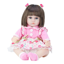 Doll with brown hair and a pink outfit 