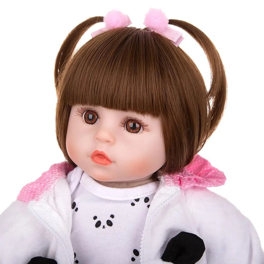 Reborn baby doll with brown pigtails in a panda outfit for lifelike dress-up play and doll collecting.