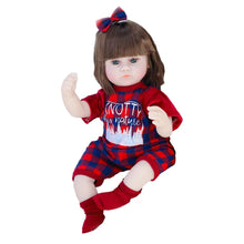 Reborn baby doll in a red plaid outfit with blue bow, a cuddly sleep doll for nursery play and gifting.