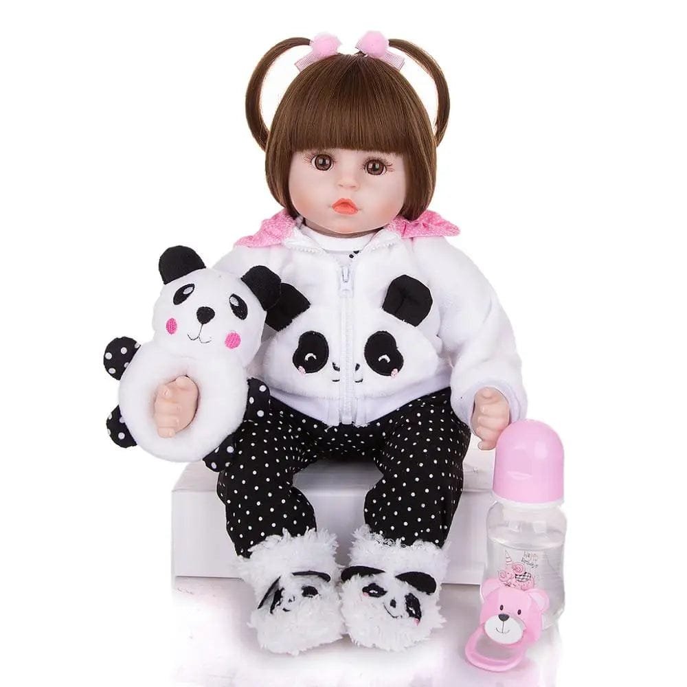 Reborn baby doll with plush toy and feeding bottle for pretend feeding and caring play.