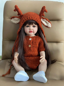 Reborn Doll silicone baby girl in a knitted deer outfit seated for cosy nursery display, pretend play, and gifting.