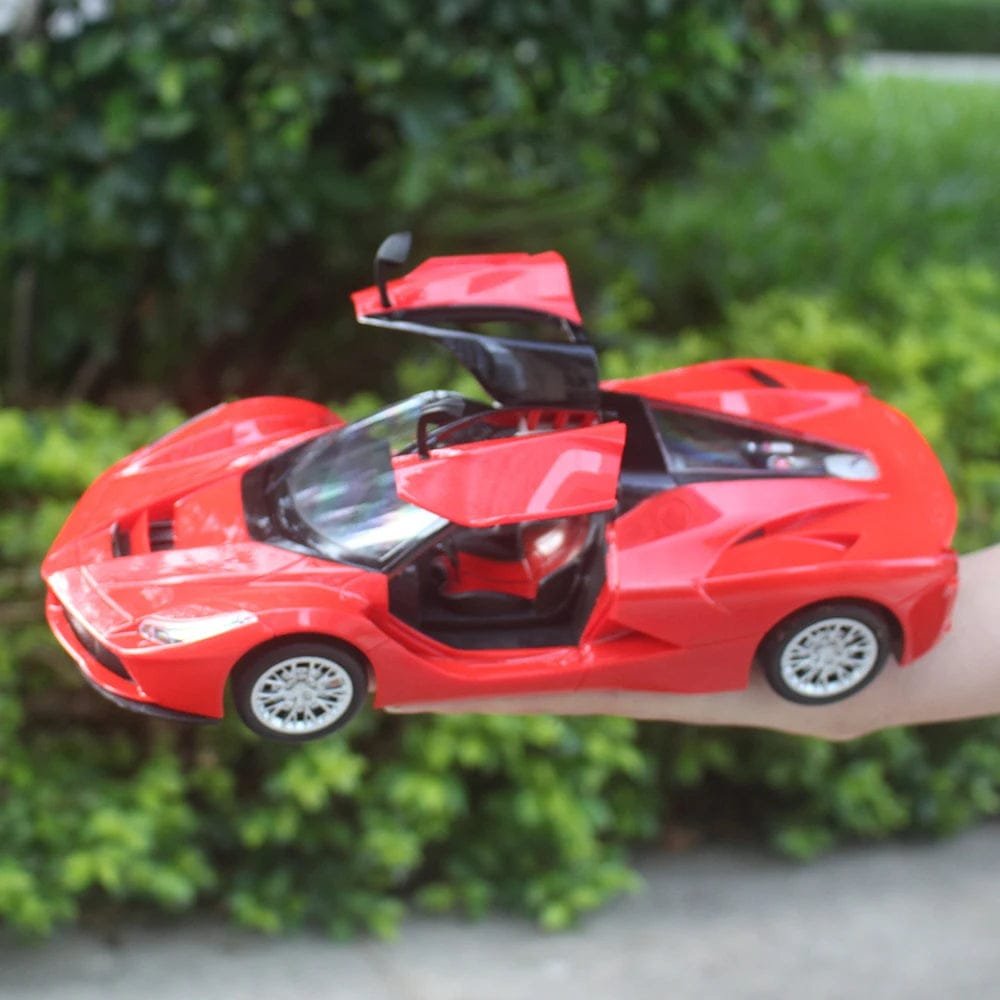 Red classical RC car with doors open held in hand, showing the scale of this collectible toy for kids play.