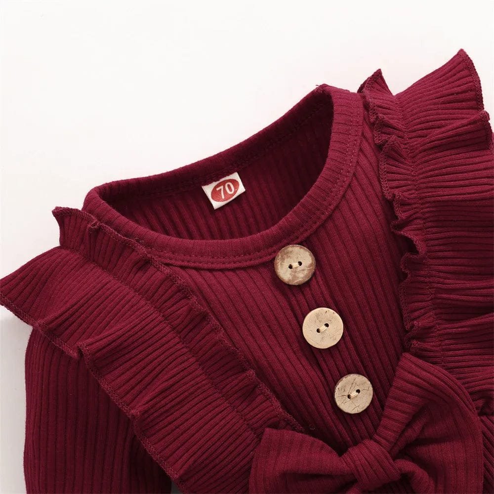 Red ribbed long-sleeve baby romper with button detail for easy dressing and quick nappy changes.