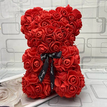 Red rose teddy bear with a black ribbon.