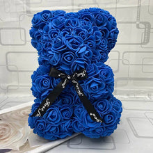 Blue rose teddy bear with a black ribbon.