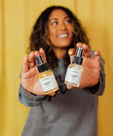 Woman holding two bottles of 'Shower Mist' 