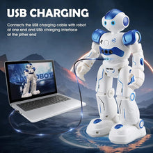 Interactive gesture robot remote control toy for children shown charging via USB from a laptop.
