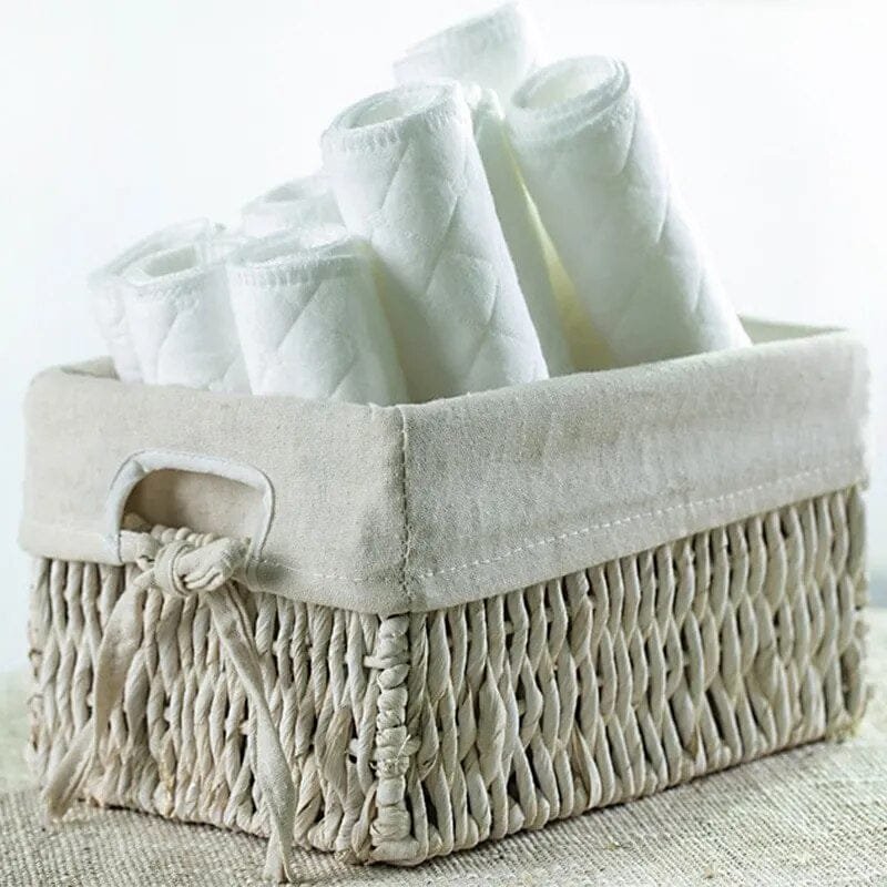 Reusable cloth diaper liners kept in a nursery basket for tidy storage, quick nappy changes, and daily baby care.