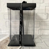 Black and clear gift box with a black ribbon.