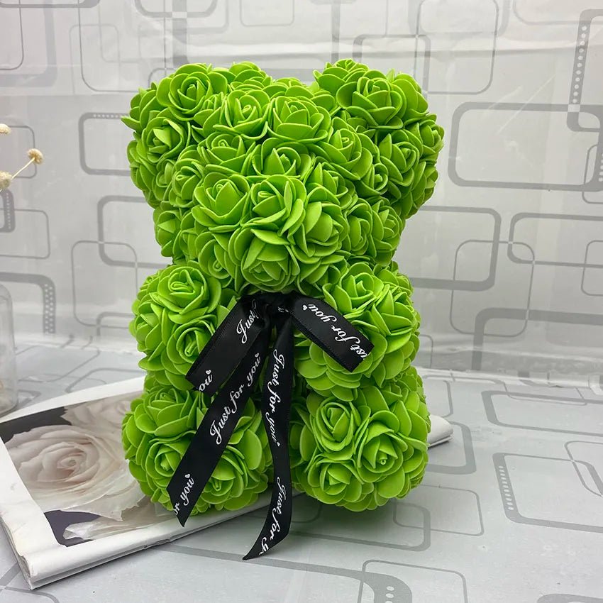 Green rose teddy bear with a black ribbon.