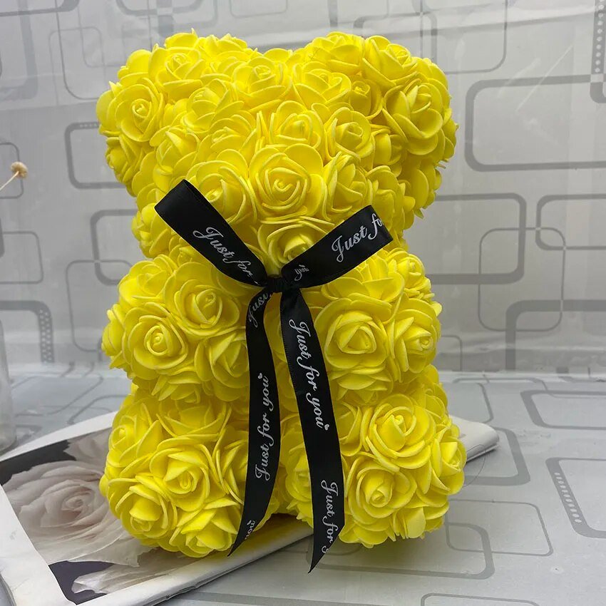 Yellow teddy bear made of roses with a black ribbon