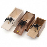 Three wooden boxes with spider toys.