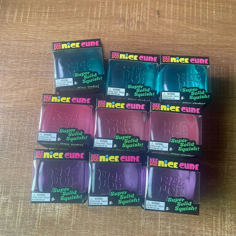 Multiple packages of Super Nice Cube on a wooden surface