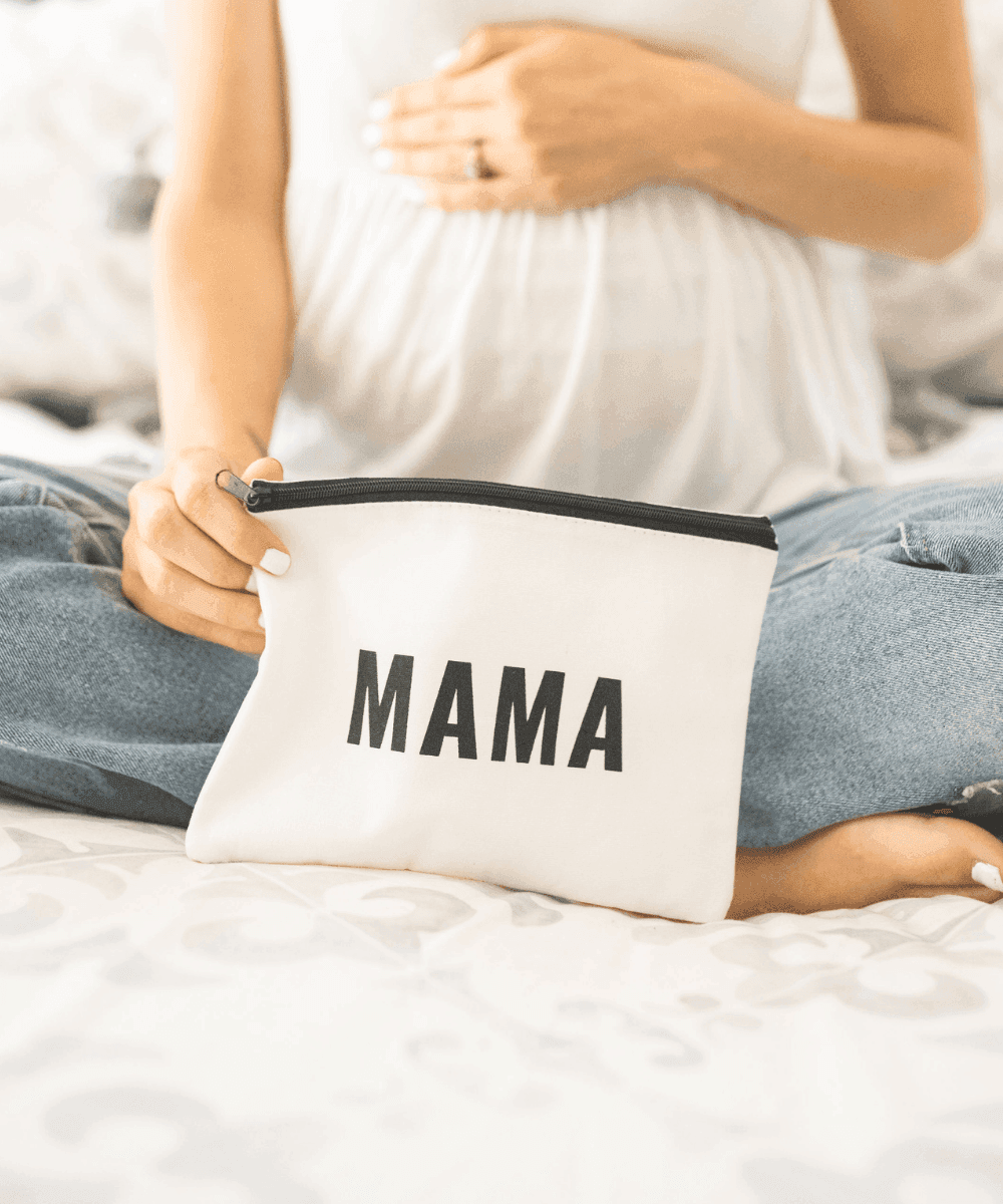 Self care mama makeup pouch styled on a bed for relaxing evening routines, travel packing, and thoughtful mom gifting.