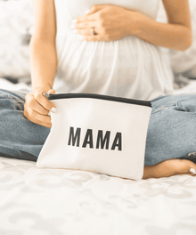 Self care mama makeup pouch styled on a bed for relaxing evening routines, travel packing, and thoughtful mom gifting.