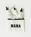 Set of skincare products including a lip balm, hand sanitizer, and hand mist on a white pouch with 'MAMA' printed on it.