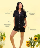 Woman wearing a black pajama set with text highlighting features