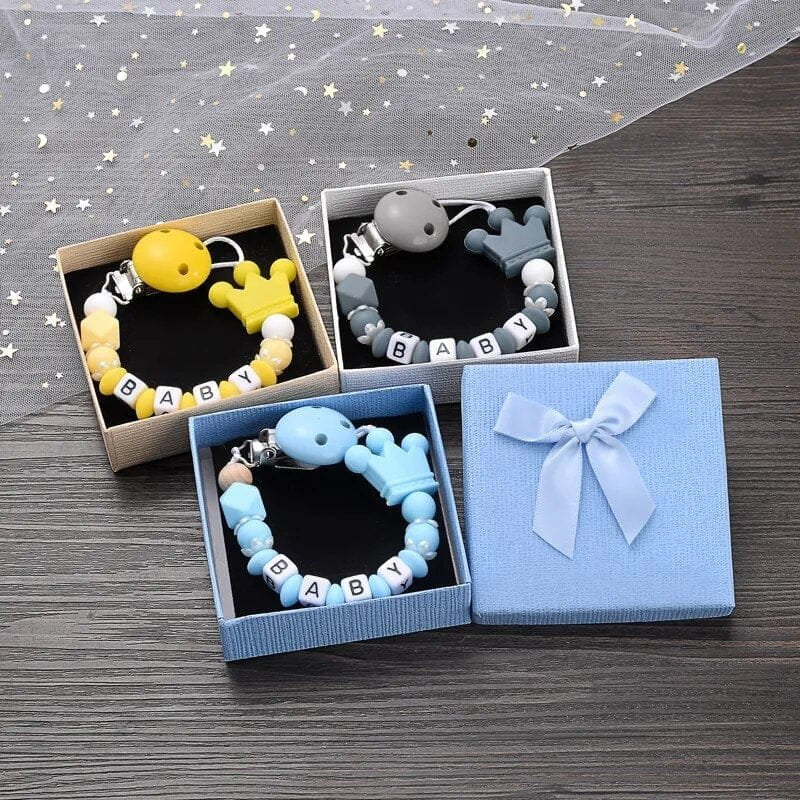 Silicone beaded chain pacifier clip design detail for personalized baby name keepsakes and daily soother use.