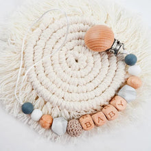 Flat lay of the silicone pacifier clip and teether set, nursery essentials for teething babies and daily outings.