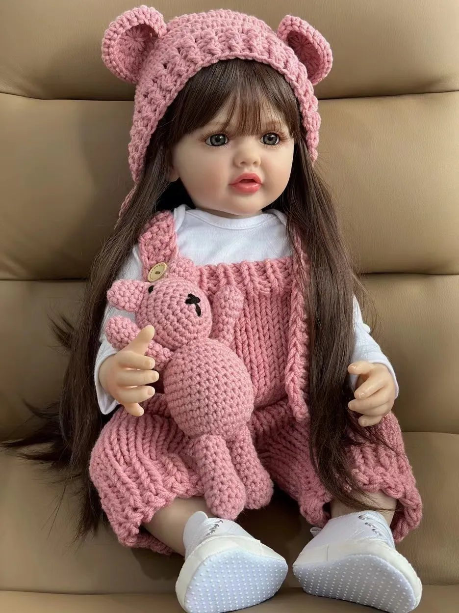 Silicone Reborn Newborn Girl Doll in a pink bear hat holding a plush bear for cosy play, nursery display, and collecting.