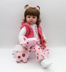 Silicone reborn toddler doll with open eyes and a pink outfit for realistic doll collecting and role play.